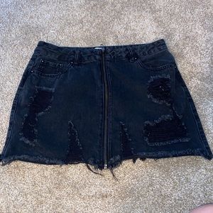 Black jean material skirt, front long zipper supper cute with ruffled edges.